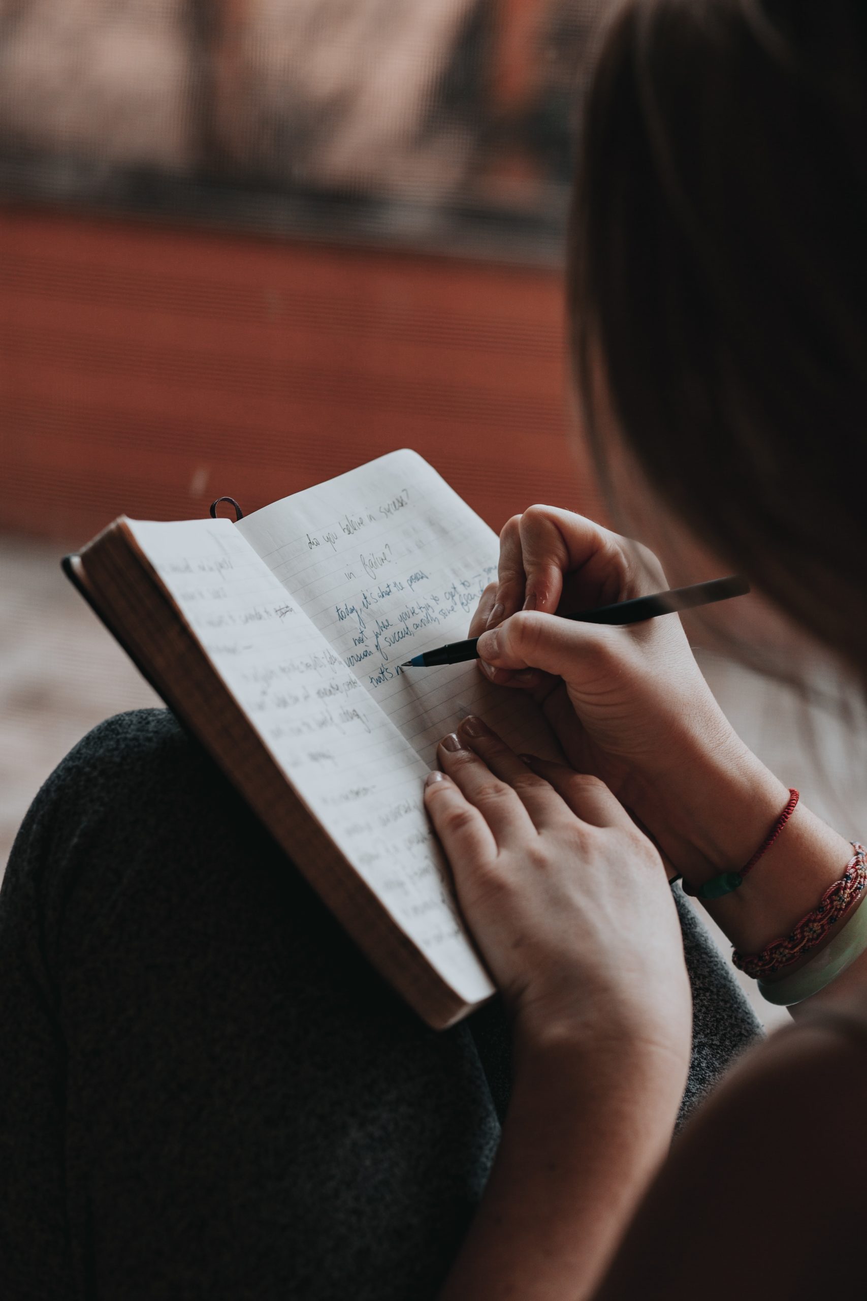 woman writing down goals